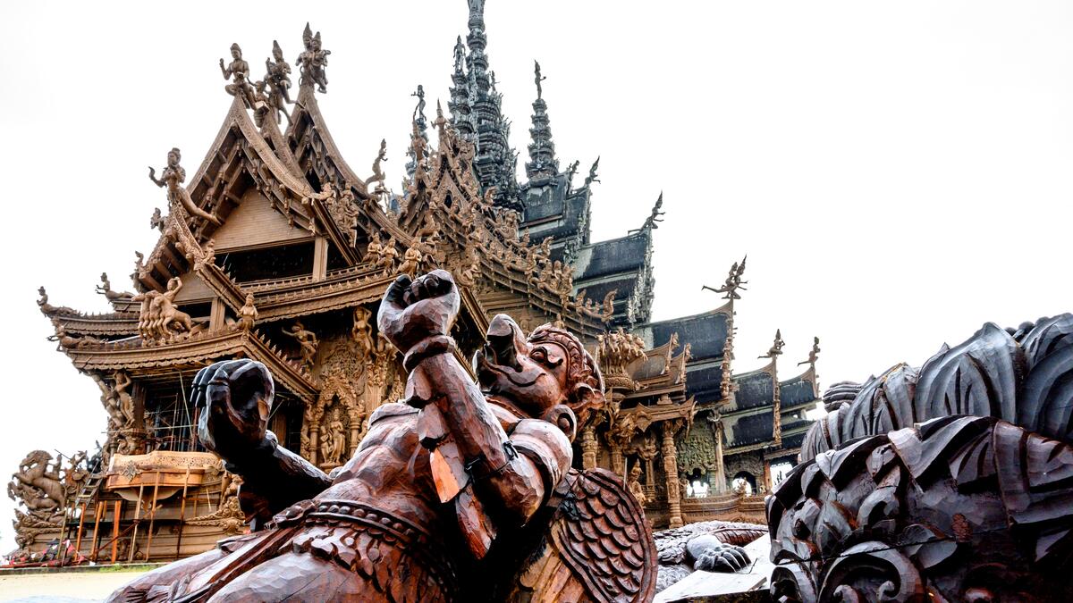 This photograph taken on September 2, 2020 shows wooden carvings in front of the all wooden Sanctuary of Truth Hindu-Buddhist temple and museum in Pattaya. Mladen ANTONOV / AFP