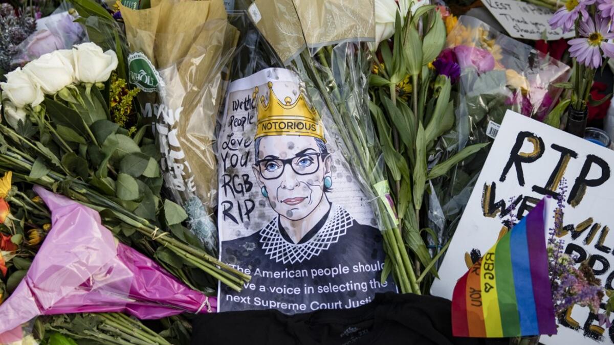 Mourners place flowers, messages, and mementos at a makeshift memorial in honor of Supreme Court Justice Ruth Bader Ginsburg in front of the US Supreme Court on September 19, 2020 in Washington, DC. Justice Ginsburg has died at age 87 after a battle with pancreatic cancer. Samuel Corum/Getty Images/AFP Samuel Corum / GETTY IMAGES NORTH AMERICA / Getty Images via AFP