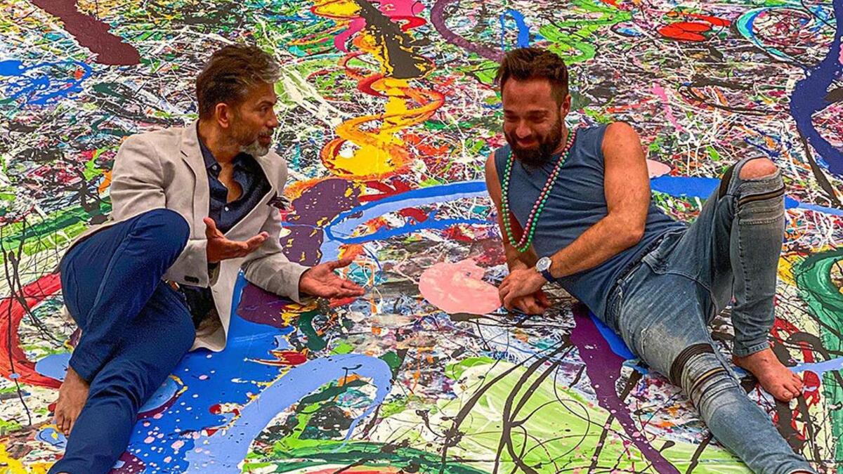 British artist Sacha Jafri paces barefoot back and forth across his giant canvas stretched across the ballroom floor of a luxury Dubai hotel, listening to a young girl singing. (Instagram)