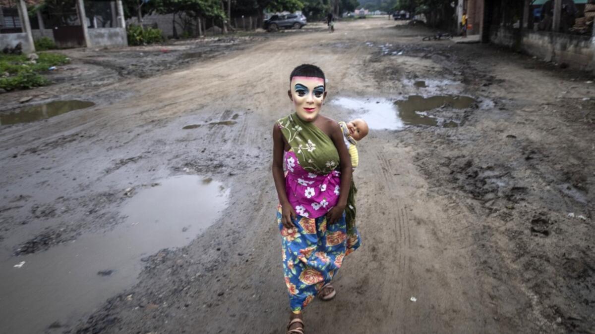A boy, member of the Afro-Mexican community and disguised as "La Minga", walks before performing Los Diablos dance, at El Pitayo community in Cuajinicuilapa, Guerrero state, Mexico, on September 10, 2020, amid the COVID-19 coronavirus pandemic. Although there are 1,5 million African descendants in a country of 128 million inhabitants, it is normal to hear that "in Mexico there are no blacks". PEDRO PARDO / AFP