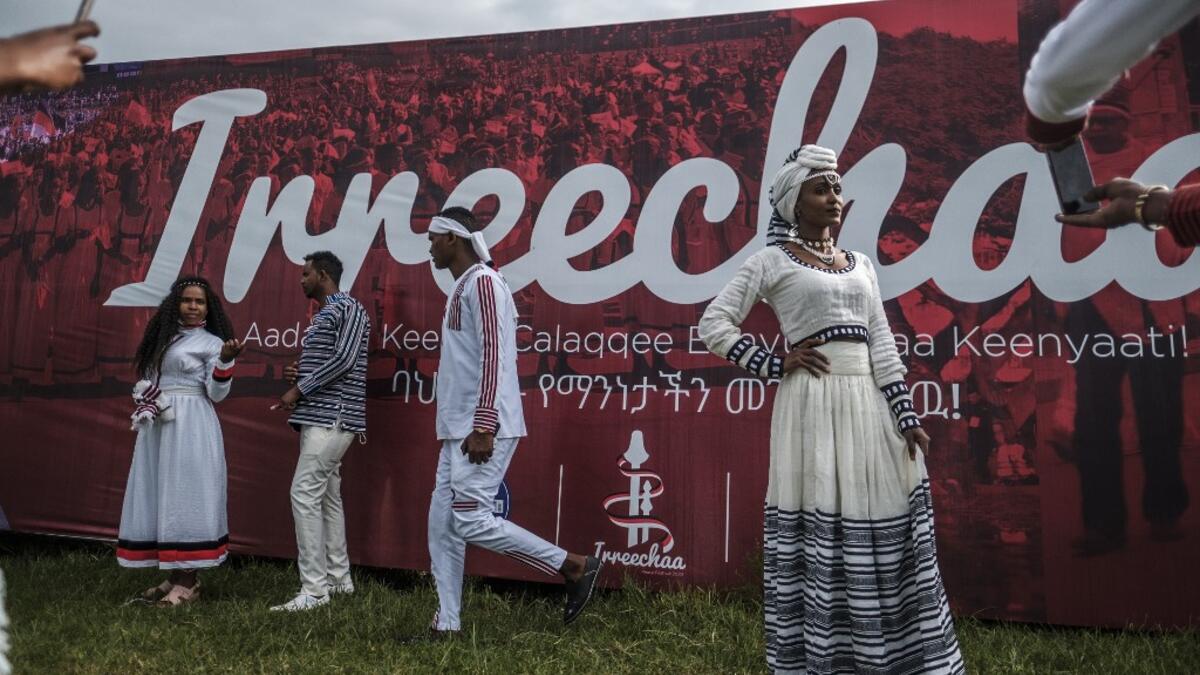 People in traditional clothing pose for pictures during the celebration of “Irreechaa”, the Oromo people thanksgiving holiday, in Addis Ababa, Ethiopia, on October 3, 2020.EDUARDO SOTERAS / AFP