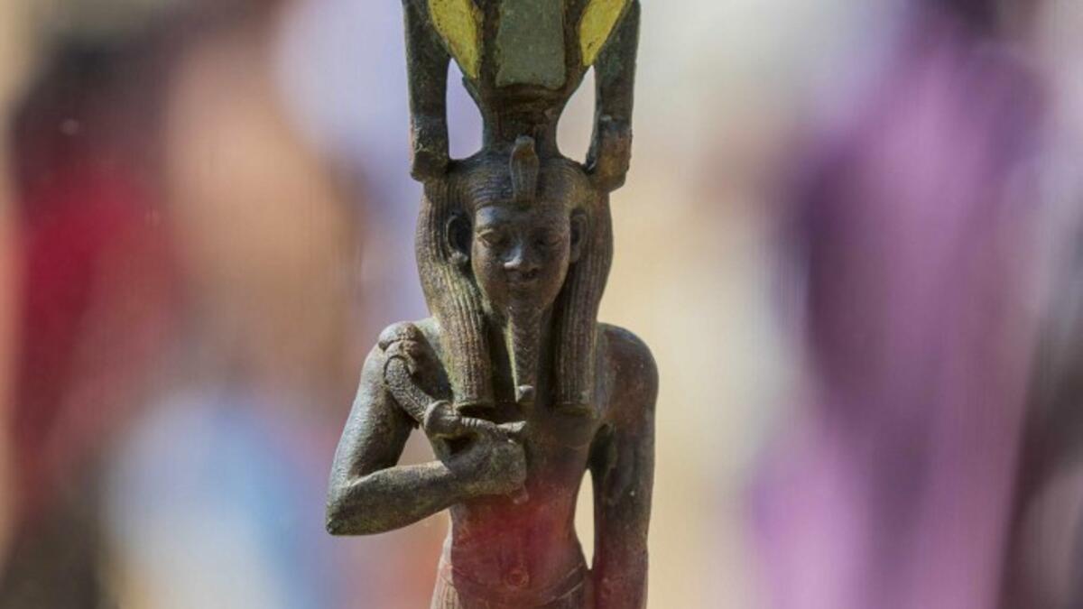 A picture taken on October 3, 2020 shows a statue, excavated by the Egyptian archaeological mission which resulted in the discovery of a deep burial well with more than 59 human coffins closed for more than 2,500 years, displayed during a press conference at the Saqqara necropolis, 30 kms south of the Egyptian capital Cairo. They were unearthed south of Cairo in the sprawling burial ground of Saqqara, the necropolis of the ancient Egyptian capital of Memphis, a UNESCO World Heritage site. Their exteriors ar
