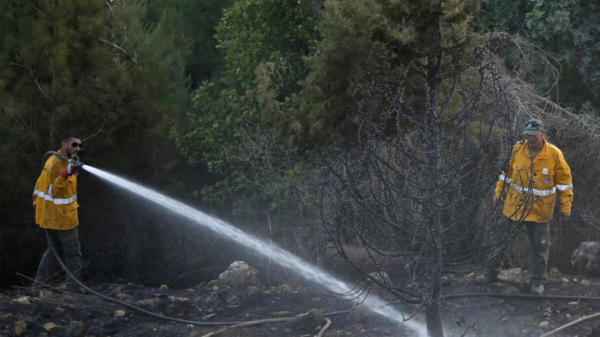 Several fires spread across northern and central Israel and the occupied West Bank as temperatures soared, forcing the evacuation of thousands of people, authorities said  JALAA MAREY / AFP