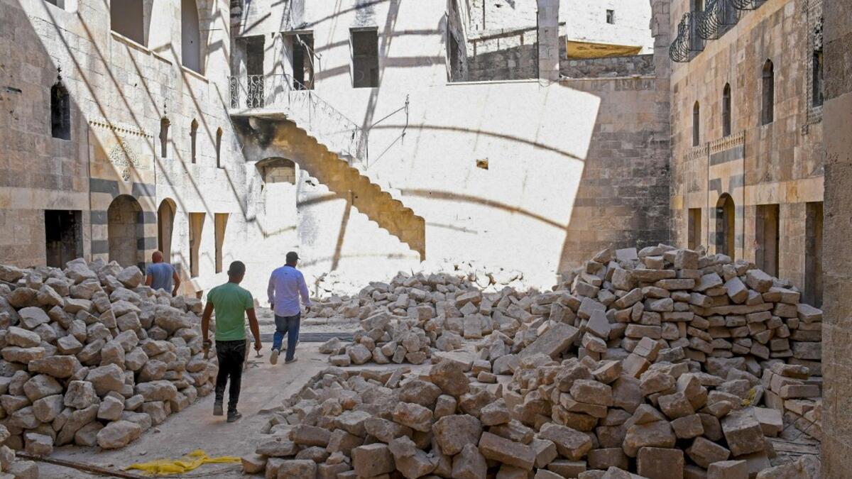 Syrian workers take part in the reconstruction of Martini restaurant and hotel in the Jdaideh neighbourhood in Aleppo's Old City on October 17, 2020. AFP