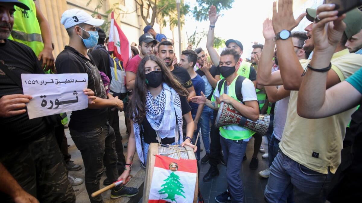 Lebanese demonstrators play music during a demonstration, marking the first anniversary of a non-sectarian protest movement, in the capital Beirut's downtown area on October 17, 2020. Anwar AMRO / AFP