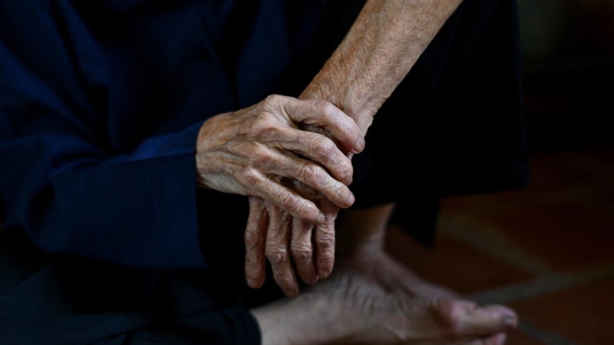This photograph taken on October 8, 2020 shows 89-year-old Vietnamese artist Mong Bich pausing while painting inside her house in Bac Ninh province, east of Hanoi. Bich specialises in silk paintings of daily life and ordinary people, women in particular, and ploughed a lonely furrow during many years of war when artists were steered towards the army or frontline workers as subjects. Manan VATSYAYANA / AFP
