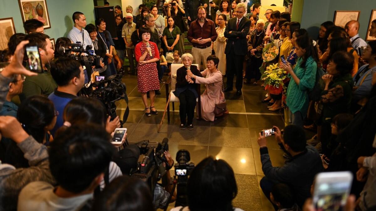 This photograph taken on October 22, 2020 shows 89-year-old Vietnamese artist Mong Bich addressing guests during the opening of her first solo exhibition at the French Cultural Centre in Hanoi. Bich specialises in silk paintings of daily life and ordinary people, women in particular, and ploughed a lonely furrow during many years of war when artists were steered towards the army or frontline workers as subjects. Manan VATSYAYANA / AFP