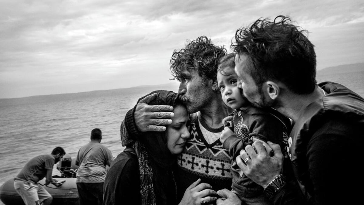 A Syrian family weeps tears of joy after reaching the Greek island of Lesbos from Turkey on a rubber boat, 10 October 2015.⁣ From ‘The Dream’ by Fabio Bucciarelli (@fabio_bucciarelli).⁣ (Instagram)