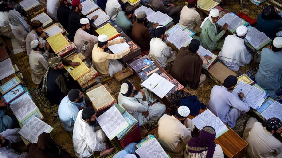 AFP Photo DOCUMENT REFERENCE000_8TL4C7 SLUGPAKISTAN - AFGHANISTAN - CONFLICT - ISLAM CREATION DATE10/19/2020 CITY/COUNTRYAKORA KHATTAK, PAKISTAN CREDITABDUL MAJEED / AFP FILE SIZE/PIXELS/DPI46.25 Mb / 4928 x 3280 / 300 dpi SPECIAL INSTRUCTIONSTO GO WITH 'PAKISTAN-AFGHANISTAN-CONFLICT-ISLAM - FOCUS' BY DAVID STOUT PAKISTAN-AFGHANISTAN-CONFLICT-ISLAM In this picture taken on October 19, 2020 Islamic seminary students attend class at the Darul Uloom Haqqania seminary in Akora Khattak. The Darul Uloom Haqqania