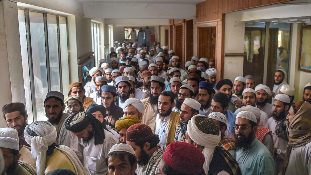 In this picture taken on October 19, 2020 Islamic seminary students leave a classroom at the Darul Uloom Haqqania seminary in Akora Khattak. The Darul Uloom Haqqania seminary has churned out a who's who of Taliban top brass -- including many now on the hardline group's negotiating team holding talks with the Kabul government to end a 20-year war. Abdul MAJEED / AFP