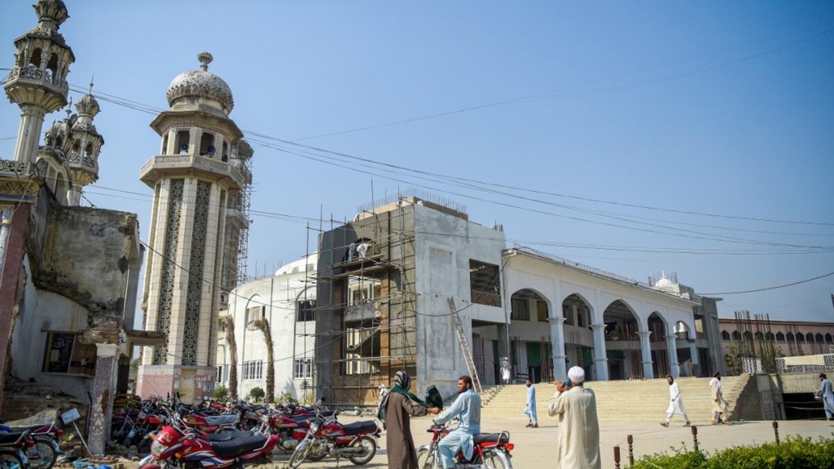 In this picture taken on October 19, 2020 Islamic seminary students stand outside the Darul Uloom Haqqania seminary in Akora Khattak. The Darul Uloom Haqqania seminary has churned out a who's who of Taliban top brass -- including many now on the hardline group's negotiating team holding talks with the Kabul government to end a 20-year war. Abdul MAJEED / AFP