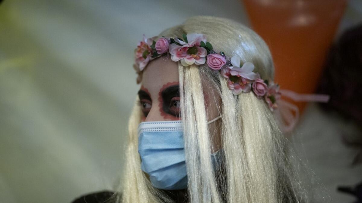A woman in Halloween costume is seen in Greenwich Village on Halloween night in Manhattan on October 31, 2020, in New York City. Kena Betancur / AFP