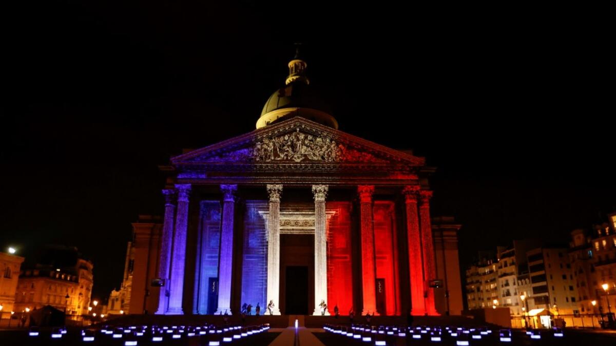 The colours of the French flag are projected on the facade of the Pantheon mausoleum during a national tribute for Late French writer Maurice Genevoix and 'Men of 14' as part of Armistice Day commemorations marking the end of World War I, on November 11, 2020, in Paris, as part of the commemorations marking the 102nd anniversary of the November 11, 1918 Armistice, ending World War I (WWI). CHRISTIAN HARTMANN / POOL / AFP
