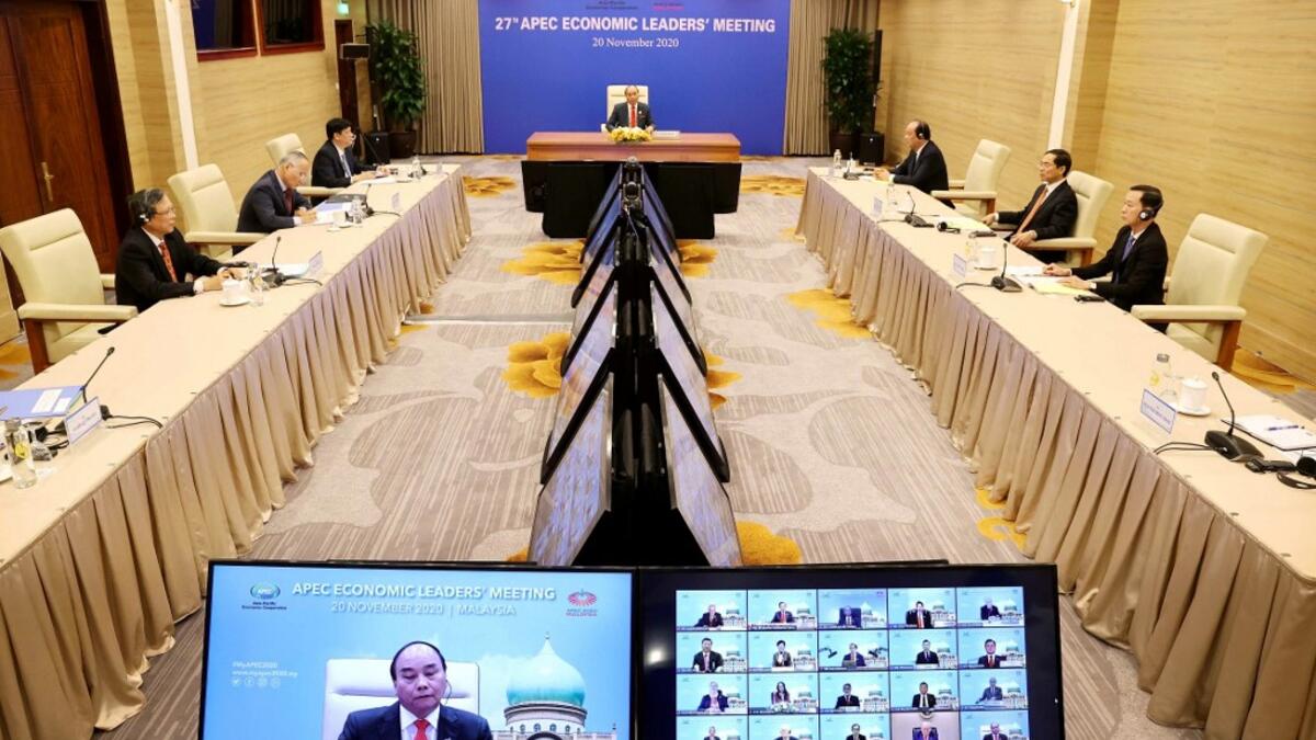 This picture taken and released by the Vietnam News Agency on November 20, 2020 shows Vietnam's Prime Minister Nguyen Xuan Phuc (C) in Hanoi, taking part in the virtual meeting between world leaders during the online Asia-Pacific Economic Cooperation (APEC) leaders' summit being held in Kuala Lumpur. STR / Vietnam News Agency / AFP
