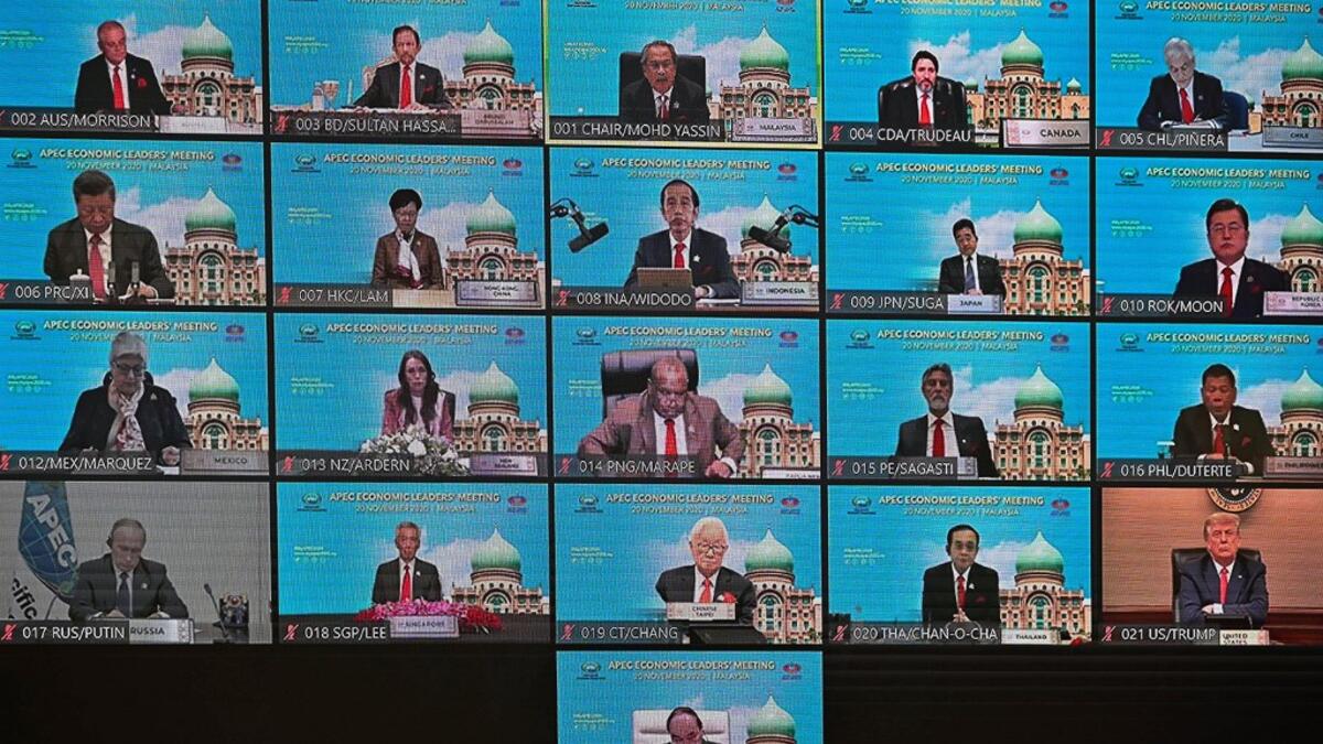 A screen shows the virtual meeting between world leaders, including US President Donald Trump (bottom R), Russian President Vladimir Putin (bottom L) and Chinese President Xi Jinping (L, second row from top), during the online Asia-Pacific Economic Cooperation (APEC) leaders' summit in Kuala Lumpur on November 20, 2020. MOHD RASFAN / AFP