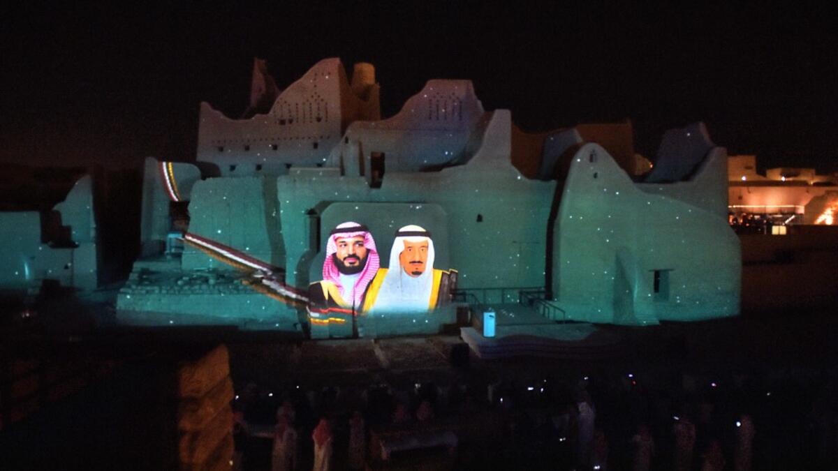 A picture of Saudi King Salman bin Abdulaziz (R) and his son Crown Prince Mohammed bin Salman is projected at the historical site of al-Tarif in Diriyah district, on the outskirts of Saudi capital Riyadh, on November 20, 2020. Saudi Arabia hosts the G20 summit on November 21 in a first for an Arab nation, with the downsized virtual forum dominated by efforts to tackle a resurgent coronavirus pandemic and crippling economic crisis. FAYEZ NURELDINE / AFP
