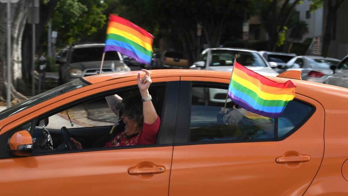 People celebrate in the streets of West Hollywood on November 07, 2020 in Los Angeles, California. KEVIN WINTER / GETTY IMAGES NORTH AMERICA / Getty Images via AFP