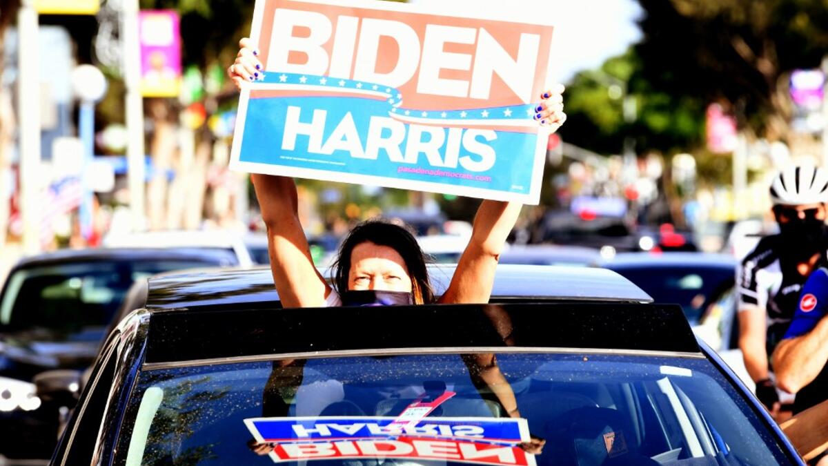 People celebrate in the streets of West Hollywood on November 07, 2020 in Los Angeles, California. KEVIN WINTER / GETTY IMAGES NORTH AMERICA / Getty Images via AFP