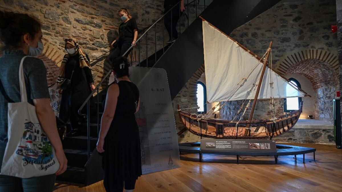 Archaelogical artfacts founds in Istanbul are on display as people visit after the restoration of the Galata Tower on October 16, 2020 in Istanbul. The Galata Tower -- an emblematic 14th century monument of Istanbul -- has become the latest victim of such controversy. Ozan KOSE / AFP