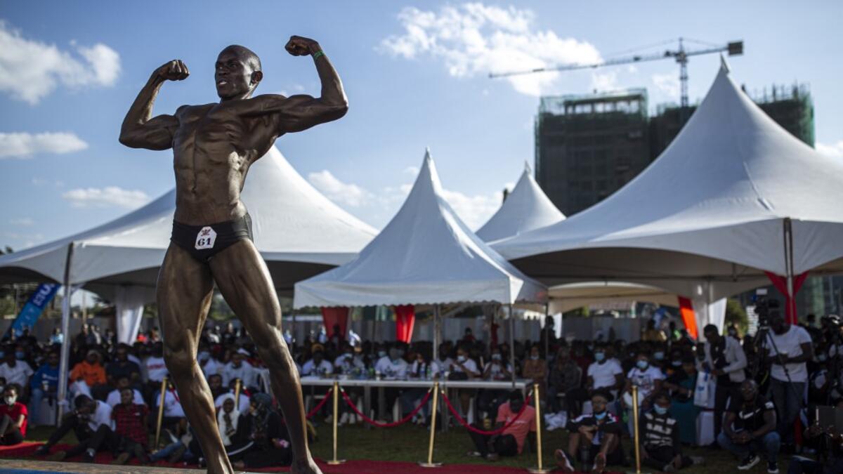 A bodybuilder poses on stage during the Iron Fit Bodybuilding competition in Nairobi on December 05, 2020. 130 participants from all across East Africa took part in the second edition of this competition which included categories like Bikini, Figure, Physique and Bodybuilding. Patrick Meinhardt / AFP