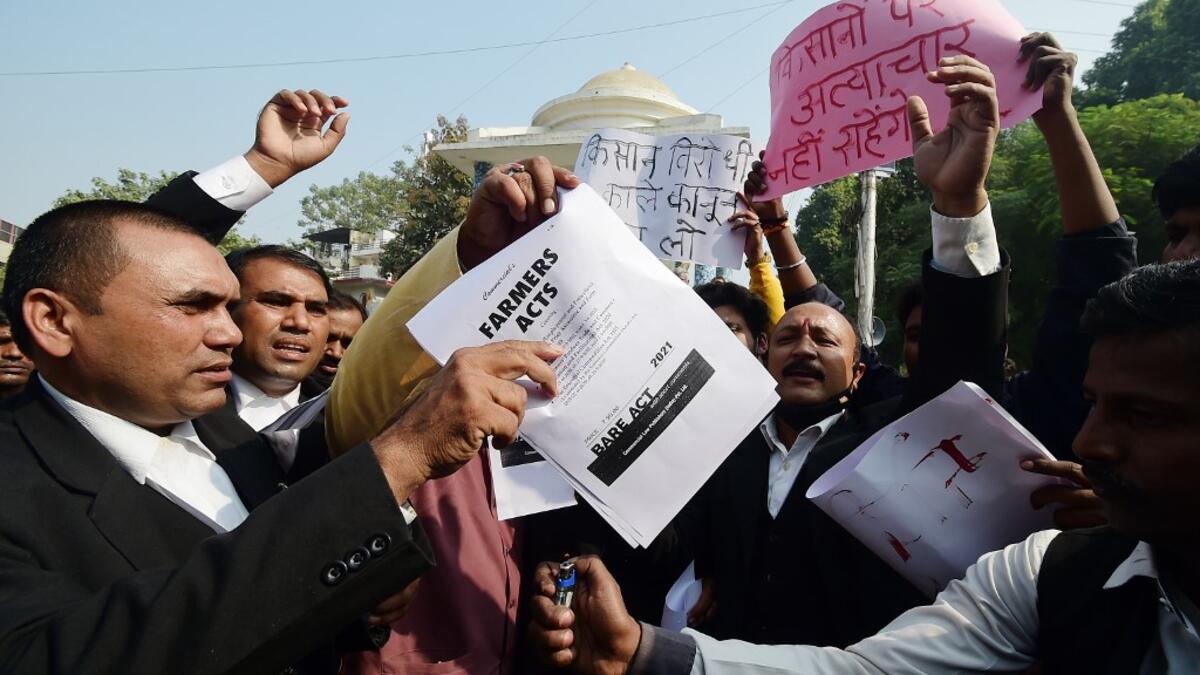 Members of All India lawyers union prepare to burn a copy of the Farmers Acts during a protest in support of the nationwide general strike called by farmers against the recent agricultural reforms in Allahabad on December 8, 2020.  SANJAY KANOJIA / AFP