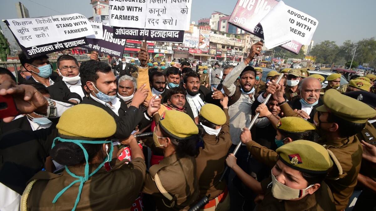 Members of All India lawyers union scuffle with police during a protest in support of the nationwide general strike called by farmers against the recent agricultural reforms in Allahabad on December 8, 2020. SANJAY KANOJIA / AFP
