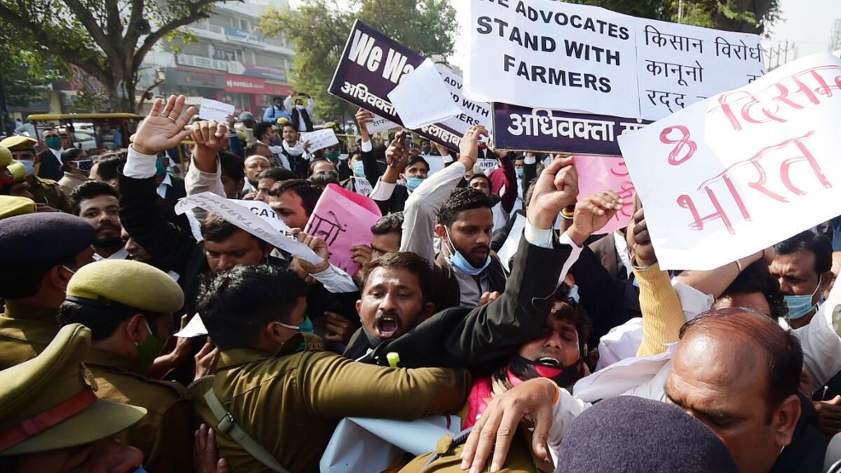 Members of All India lawyers union scuffle with police during a protest in support of the nationwide general strike called by farmers against the recent agricultural reforms in Allahabad on December 8, 2020. SANJAY KANOJIA / AFP