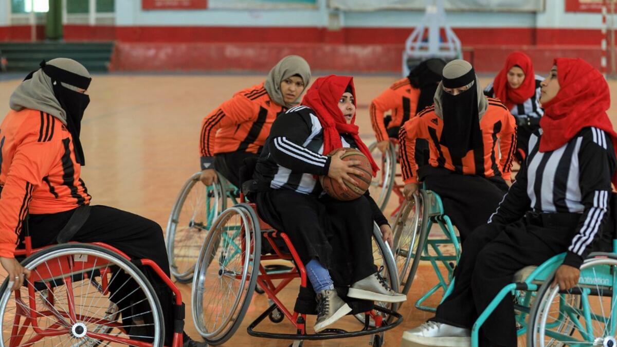 Disabled Yemeni women take part in a local wheelchair basketball championship in Yemen's capital Sanaa on December 8, 2020. In conflict-ridden Yemen, nine teams, including five-all women groups, competed in a local championship for the disabled in the capital Sanaa, which has been under rebel control since 2014. The players are competing to be embraced by society for their strengths rather than be viewed as a burden during the time of war. Mohammed HUWAIS / AFP