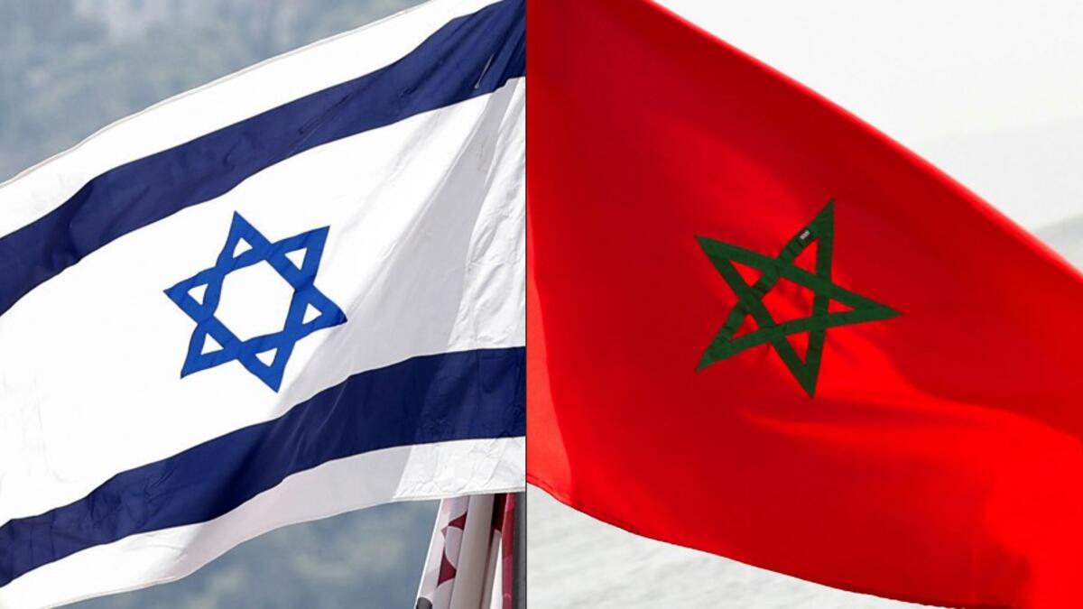 This combination of file pictures created on December 10, 2020 shows a Moroccan flag off the coasts of the city of Cayenne on March 21, 2012 and an Israeli national flag on September 23, 2020. Morocco confirmed on December 10, 2020 it would resume diplomatic relations with Israel "with minimal delay" and lauded as "historic" a decision by Washington to recognise Moroccan sovereignty over the disputed Western Sahara region. JACK GUEZ, Jody AMIET / AFP