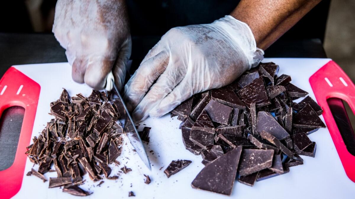 Preparation of a chocolate ganache with local rum by chocolate maker Ralph Leroy in the workshops of Makaya Chocolat on December 23, 2020 in Petionville, Haiti. Although small in the face of South America's giants, Haiti is slowly developing its cocoa industry to ensure better incomes for thousands of modest farmers and to end the stereotype of gastronomic art known as the domain of wealthy countries. Valerie Baeriswyl / AFP