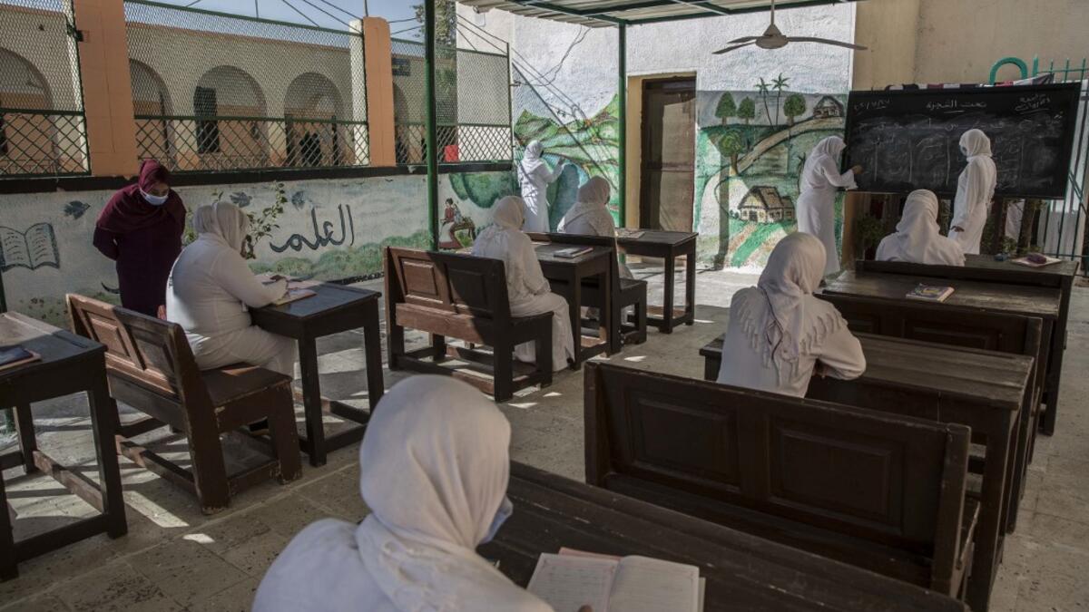 This picture taken during a government-guided tour on December 27, 2020 shows inmates attending a literacy class at al-Qanatir women's prison, at the tip of the Nile delta in Qalyoubiya province, about 30 kilometres north of Egypt's capital. Khaled DESOUKI / AFP