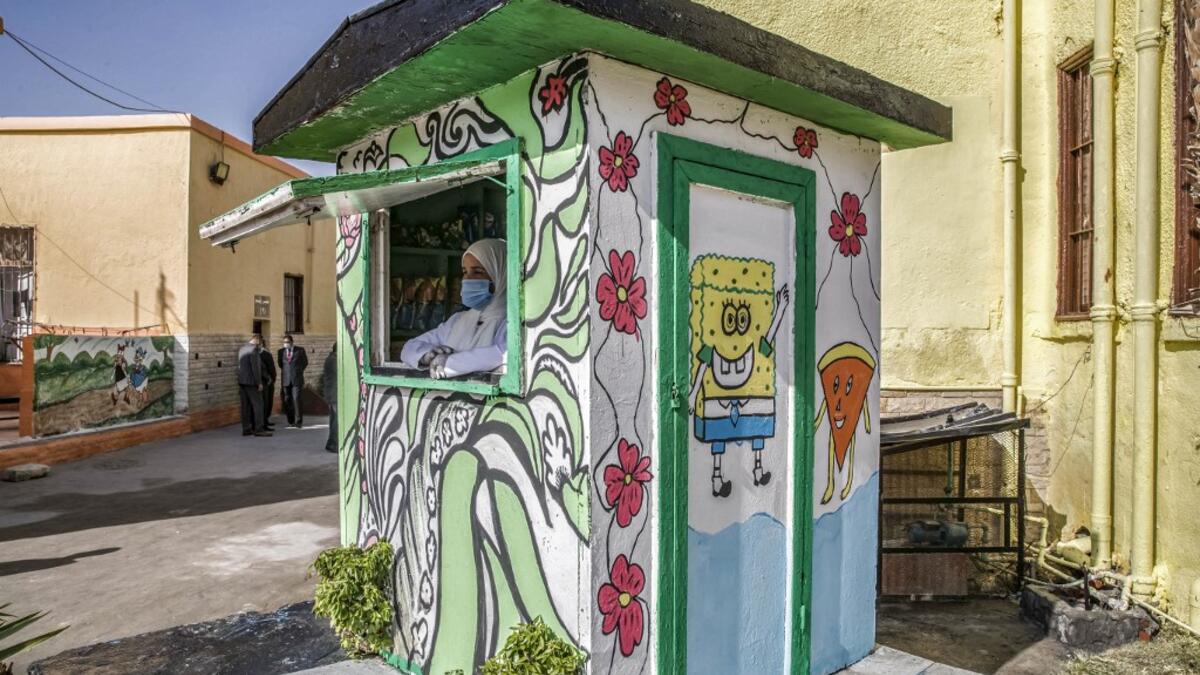 This picture taken during a government-guided tour on December 27, 2020 shows an inmate, mask-clad due to the COVID-19 coronavirus pandemic, manning a commissary stall at al-Qanatir women's prison, at the tip of the Nile delta in Qalyoubiya province, about 30 kilometres north of Egypt's capital. Khaled DESOUKI / AFP