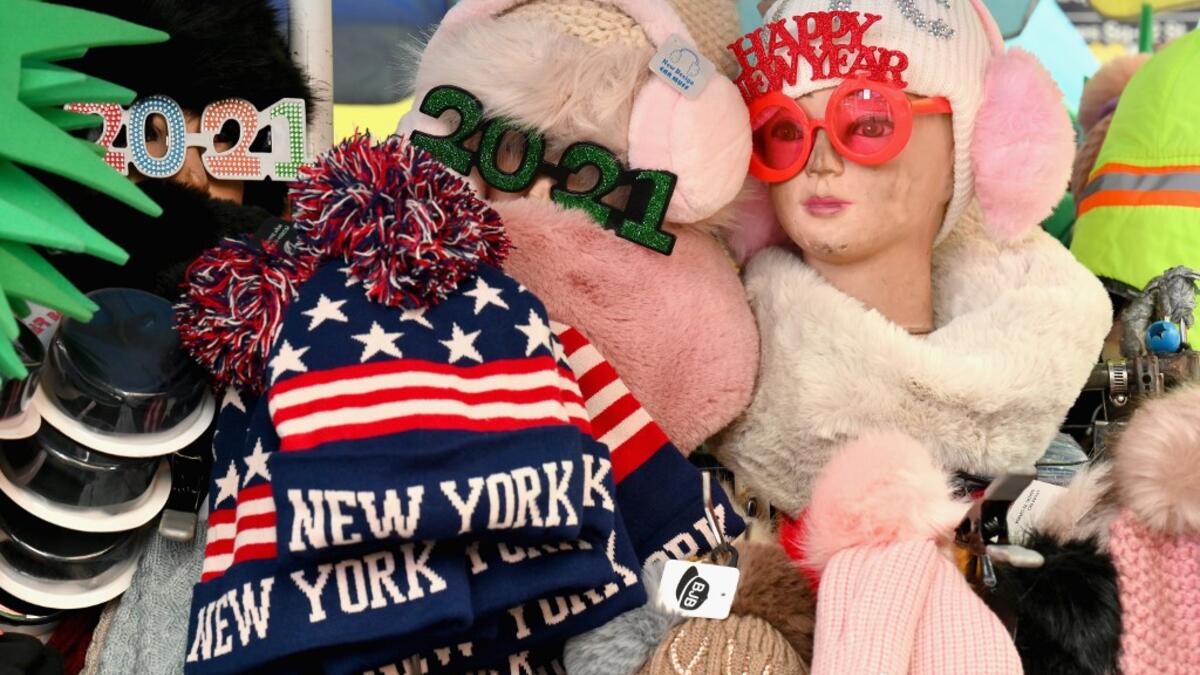 Souvenirs are seen at a stand at Times Square ahead of New Year's Eve celebrations on December 28, 2020 in New York City. - The pandemic has caused long-term repercussions throughout the tourism and entertainment industries, including temporary and permanent closures of historic and iconic venues, costing the city and businesses billions in revenue. Angela Weiss / AFP