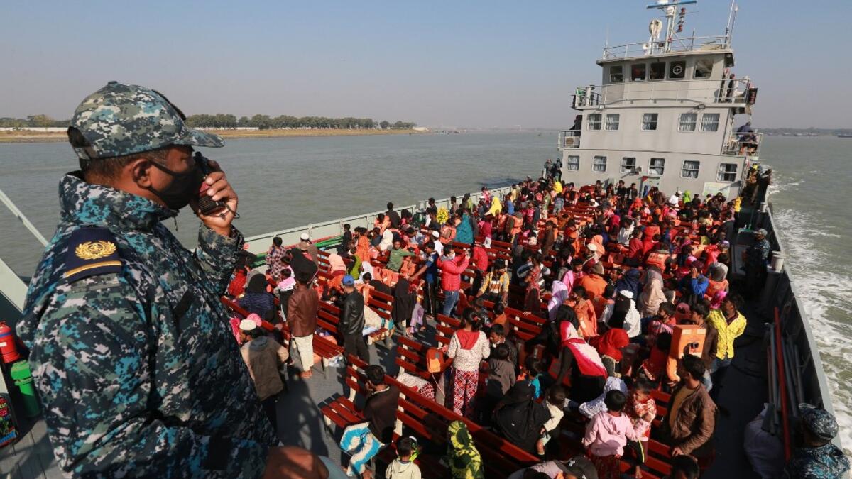Rohingya refugees sit on a Bangladesh Navy ship as they are relocated to the controversial flood-prone island Bhashan Char in the Bay of Bengal, in Chittagong on December 29, 2020. Rehman ASAD / AFP