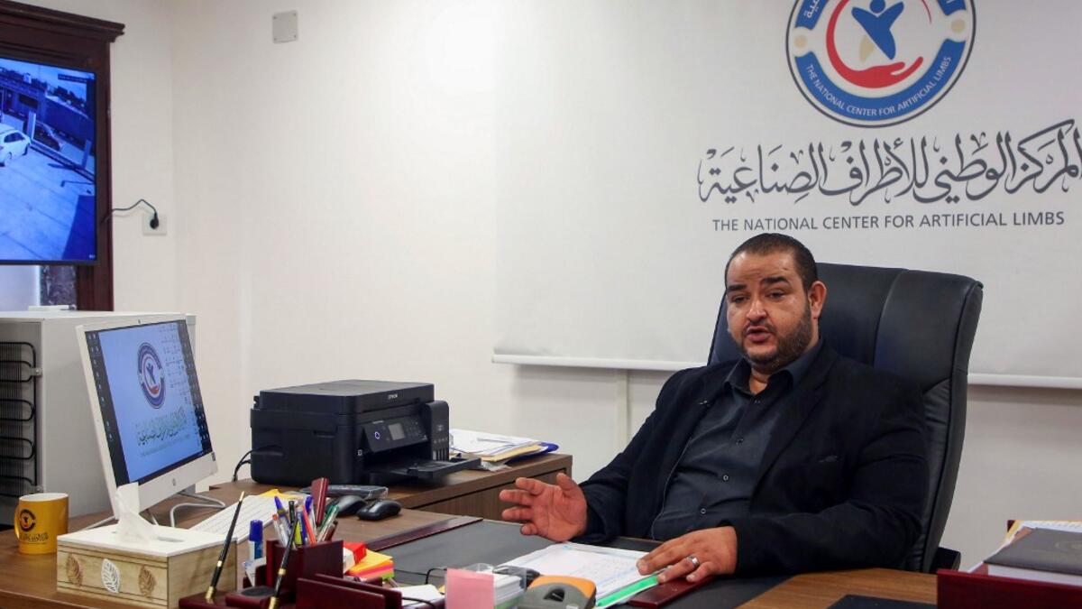 Director of the National Center for Artificial Limbs Al-Sadeq Al-Haddad, speaks during an interview at his office in Libya's port city of Misrata, on December 17, 2020. MAHMUD TURKIA / AFP