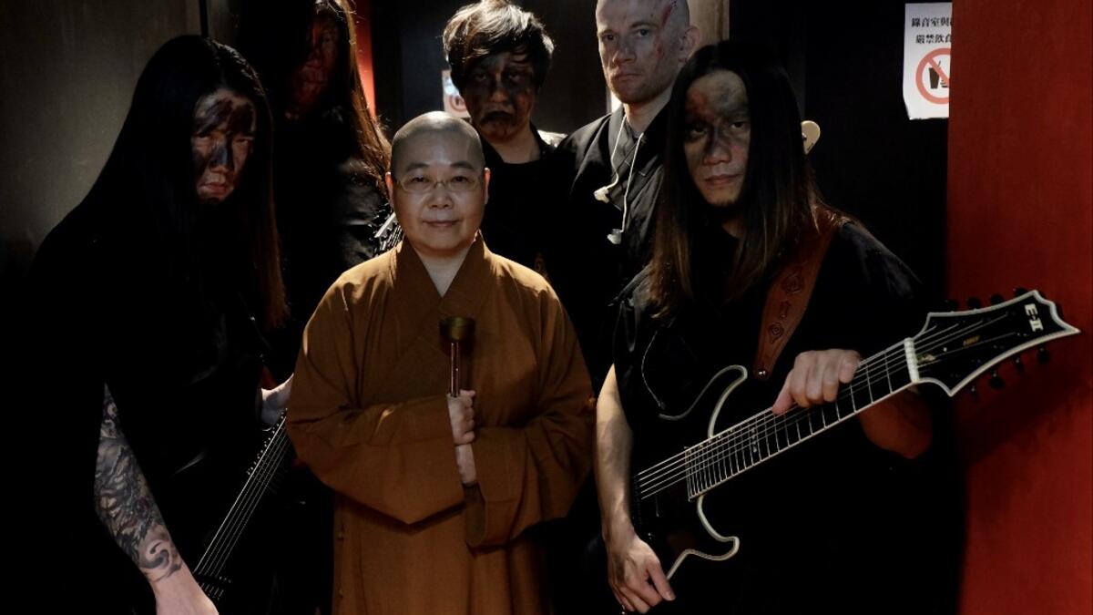 This picture taken on December 3, 2020 shows members of Taiwanese death metal band 'Dharma' posing for photographs during a rehearsal in Taipei. Sam Yeh / AFP