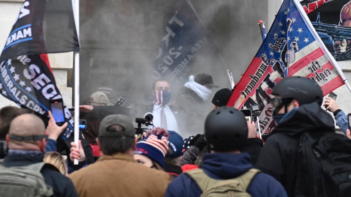 Trump supporters are getting tear gassed outside the US Capitol in Washington, DC on January 6, 2021. Demonstrators breeched security and entered the Capitol as Congress debated the a 2020 presidential election Electoral Vote Certification. ANDREW CABALLERO-REYNOLDS / AFP