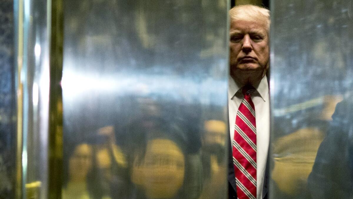 AFP presents a retrospective photo package of 60 pictures marking the 4-year presidency of President Trump. US President-elect Donald Trump boards the elevator after escorting Martin Luther King III to the lobby after meetings at Trump Tower in New York City on January 16, 2017. DOMINICK REUTER / AFP