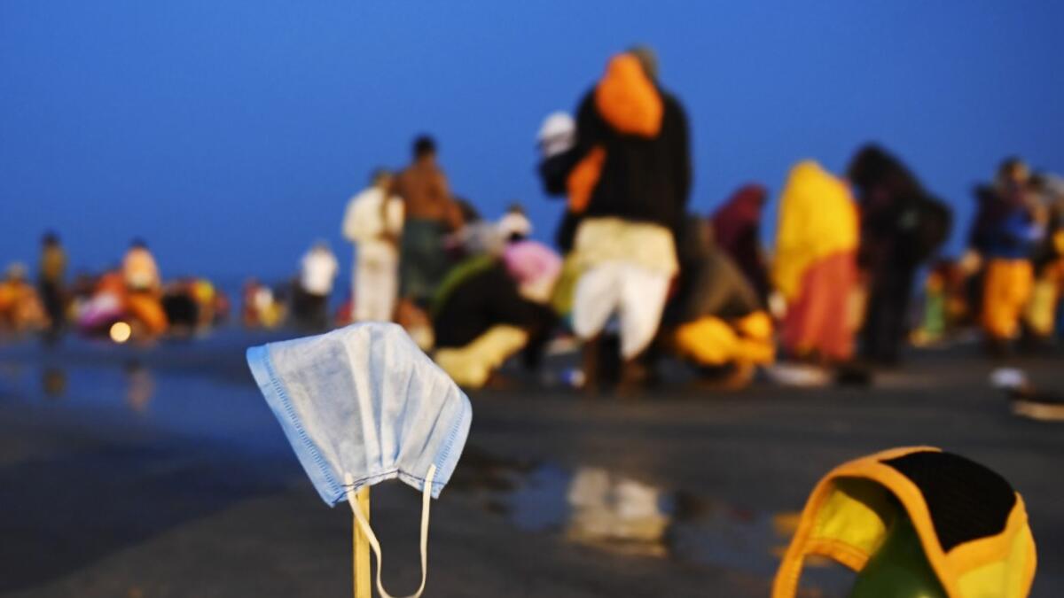 Facemasks of Hindu pilgrims kept for drying are pictured at the confluence of Ganges and the Bay of Bengal during the Gangasagar Mela on the occasion of Makar Sankranti, a day considered to be of great religious significance in Hindu mythology, at Sagar Island, around 150 kms south of Kolkata on January 14, 2021. Dibyangshu SARKAR / AFP