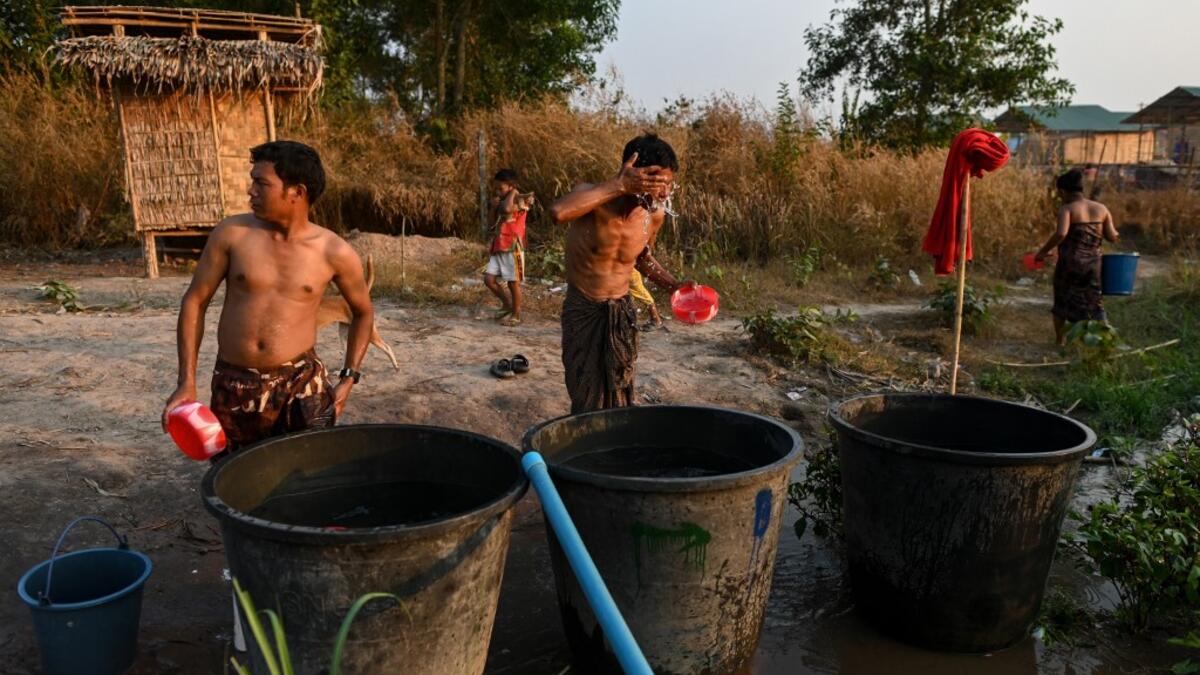 This photo taken on January 11, 2021 shows Chin ethnic people washing in Bethel village in Hmawbi, on the outskirts of Yangon, where hundreds of members of the Chin ethnic community have settled after being displaced by fighting between Myanmar's military and the Arakan Army in the country's north.  Ye Aung THU / AFP
