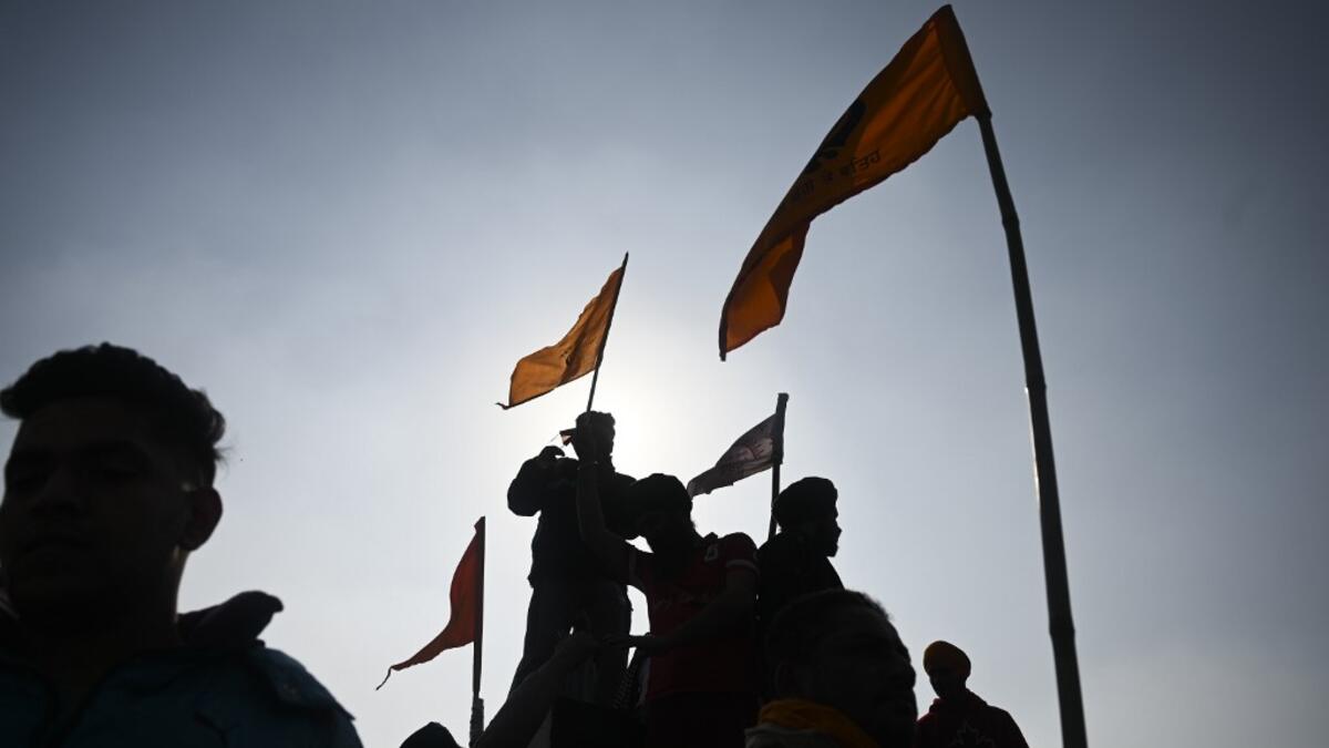 Protesters shout slogans in front of the Red Fort as farmers continue to protest against the central government's recent agricultural reforms in New Delhi on January 26, 2021. Sajjad HUSSAIN / AFP