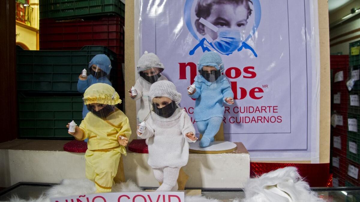 View of dolls displayed for sale at the ¨Nino Uribe¨ traditional Mexican store in Mexico City on January 27, 2021. ¨Nino Uribe¨ sells representations of the Baby Jesus called Baby COVID to raise awareness on the preventive measures to take amid the COVID-19 coronavirus pandemic. CLAUDIO CRUZ / AFP