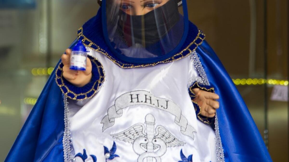 View of a doll displayed for sale at the ¨Nino Uribe¨ traditional Mexican store in Mexico City on January 27, 2021. ¨Nino Uribe¨ sells representations of the Baby Jesus called Baby COVID to raise awareness on the preventive measures to take amid the COVID-19 coronavirus pandemic. CLAUDIO CRUZ / AFP