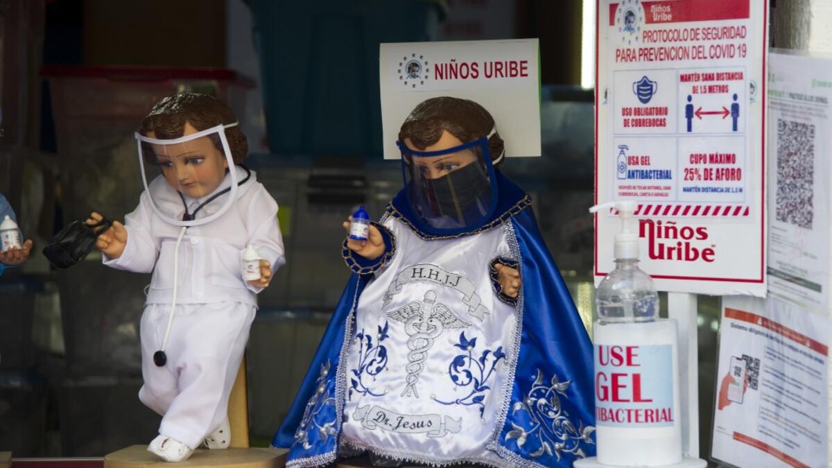 View of dolls displayed for sale at the ¨Nino Uribe¨ traditional Mexican store in Mexico City on January 27, 2021. ¨Nino Uribe¨ sells representations of the Baby Jesus called Baby COVID to raise awareness on the preventive measures to take amid the COVID-19 coronavirus pandemic. CLAUDIO CRUZ / AFP