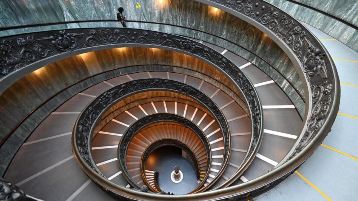A man walks down the Bramante Staircase as he visits the Vatican museum on its reopening day, on February 1, 2021 in Vatican City, as the city-state eases its closure aimed at curbing the spread of the COVID-19 infection, caused by the new coronavirus. Andreas SOLARO / AFP