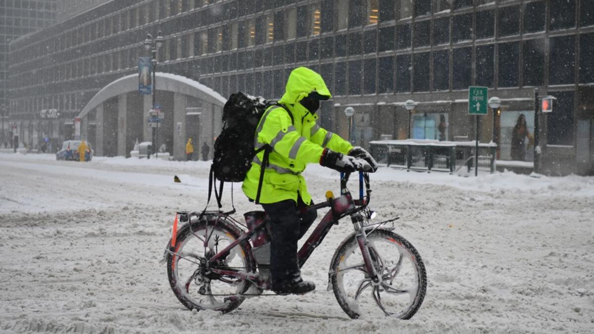 A person on a delivery bike rides during a winter storm on February 1, 2021 in New York City. A powerful winter storm is set to dump feet of snow along a stretch of the US east coast including New York City on February 1, 2021, after blanketing the nation's capital. The National Weather Service issued storm warnings from Virginia to Maine -- a swathe home to tens of millions of people -- and forecast snowfall of 18 to 24 inches (45-60 centimeters) in southern New York, northeastern New Jersey and parts of s