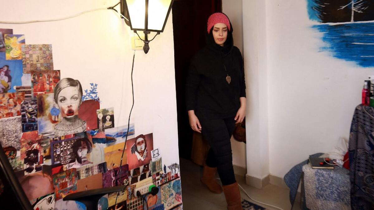 Jordanian make-up artist Alaa Bliha, 27, enters her room in the basement apartment where she lives with her mother and young brother in the capital Amman, on February 2, 2021. Bliha has beaten the lockdown blues and shot to online fame with videos of herself imitating famous figures from across the Arab world and beyond. From Donald Trump and Queen Elizabeth II to Egyptian superstars like singer Umm Kalthum and actor Adel Imam, her characters have made Alaa Bliha a star in her own right, with tens of thousa