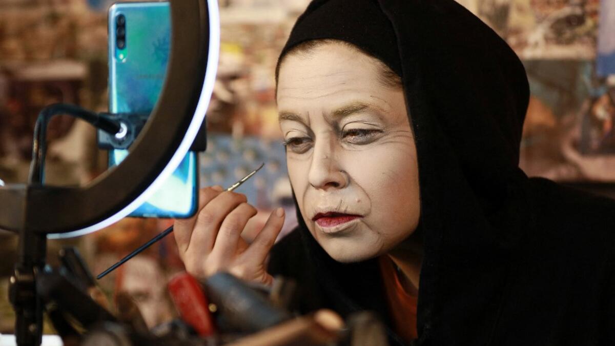 Jordanian make-up artist Alaa Bliha, 27, works on her imitation make-up to resemble Queen Elizabeth II, in the basement apartment where she lives with her mother and young brother in the capital Amman, on February 2, 2021. Bliha has beaten the lockdown blues and shot to online fame with videos of herself imitating famous figures from across the Arab world and beyond. From Donald Trump and Queen Elizabeth II to Egyptian superstars like singer Umm Kalthum and actor Adel Imam, her characters have made Alaa Bli