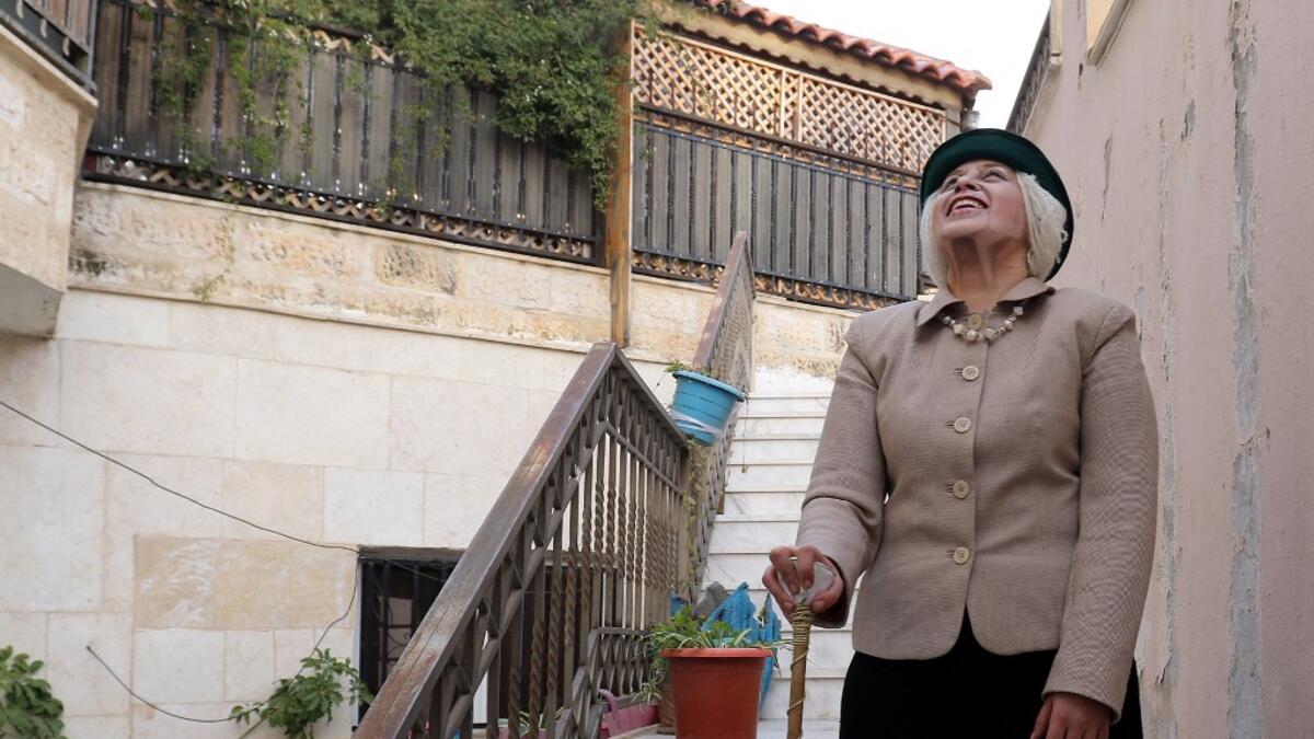 Jordanian make-up artist Alaa Bliha, 27, poses for a picture after completing her make-up to resemble Queen Elizabeth II, near the basement apartment where she lives with her mother and young brother in the capital Amman, on February 2, 2021. Bliha has beaten the lockdown blues and shot to online fame with videos of herself imitating famous figures from across the Arab world and beyond. From Donald Trump and Queen Elizabeth II to Egyptian superstars like singer Umm Kalthum and actor Adel Imam, her character