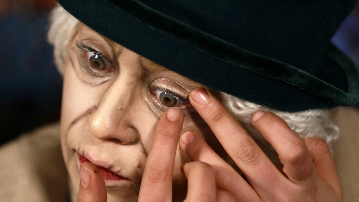 Jordanian make-up artist Alaa Bliha, 27, applies coloured eye lenses to complete her imitation make-up to resemble Queen Elizabeth II, in the basement apartment where she lives with her mother and young brother in the capital Amman, on February 2, 2021. Bliha has beaten the lockdown blues and shot to online fame with videos of herself imitating famous figures from across the Arab world and beyond. From Donald Trump and Queen Elizabeth II to Egyptian superstars like singer Umm Kalthum and actor Adel Imam, he